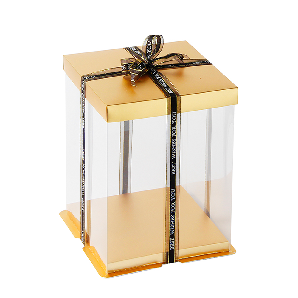 Gold gift box with a clear front and black ribbon on a white background
